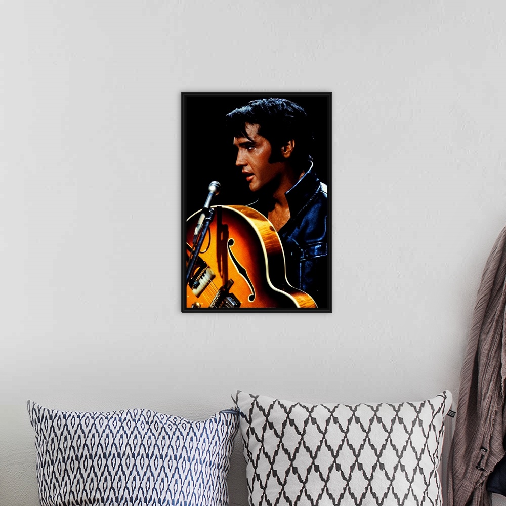 A bohemian room featuring Big canvas photo of an up close shot of Elvis Presley holding a guitar in front of a microphone.