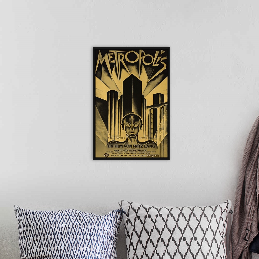 A bohemian room featuring Poster for the 1927 science fiction film Metropolis. Skyscrapers line the back of the poster with...