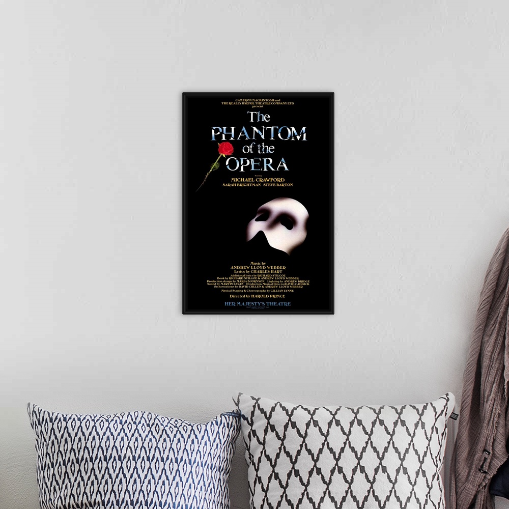 A bohemian room featuring Broadway poster for Andrew Lloyd Webber's play, The Phantom of the Opera, displaying the Phantom'...