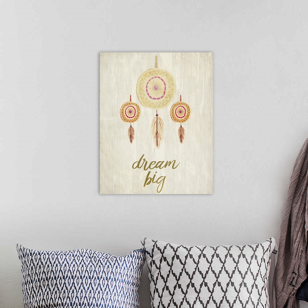 A bohemian room featuring Three dreamcatchers with feathers hanging over the words "Dream Big."