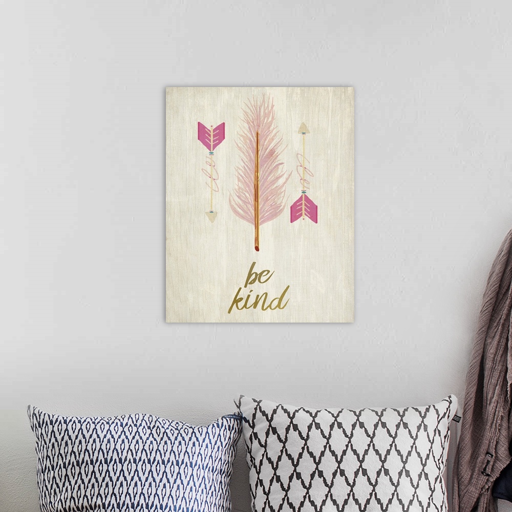 A bohemian room featuring A pink feather with pink arrows over the words "Be Kind."