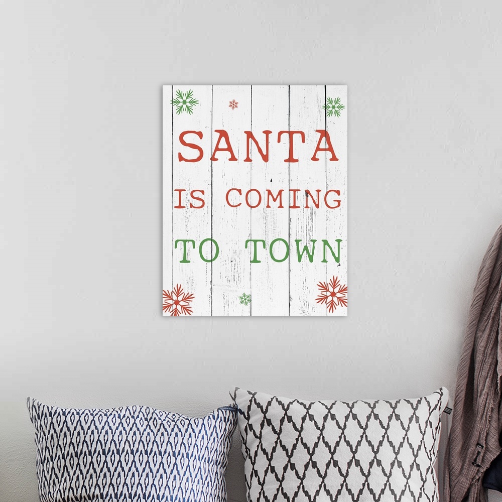 A bohemian room featuring Simple Christmas typography artwork in green and red on white.