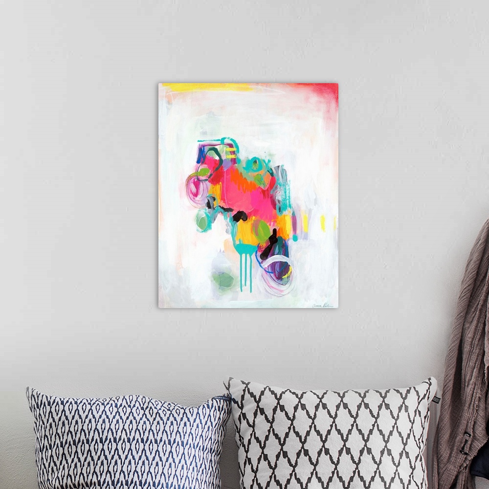A bohemian room featuring Abstract mixed media artwork with vivid pink, teal, and yellow color on white.