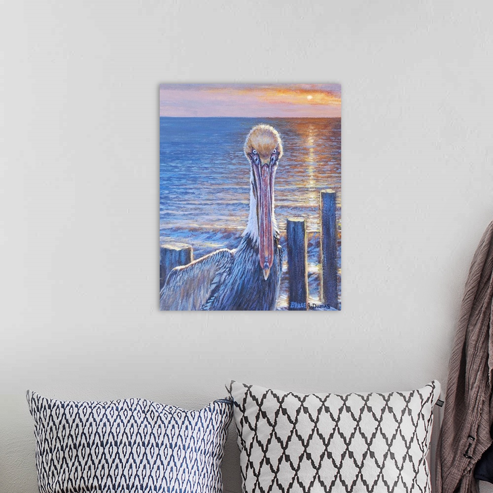 A bohemian room featuring Contemporary painting of a pelican on the beach at sunset, next to some wooden posts.