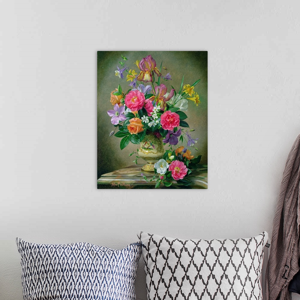 A bohemian room featuring A large vertical painting of colorful flowers inside an antique vase with a neutral background.