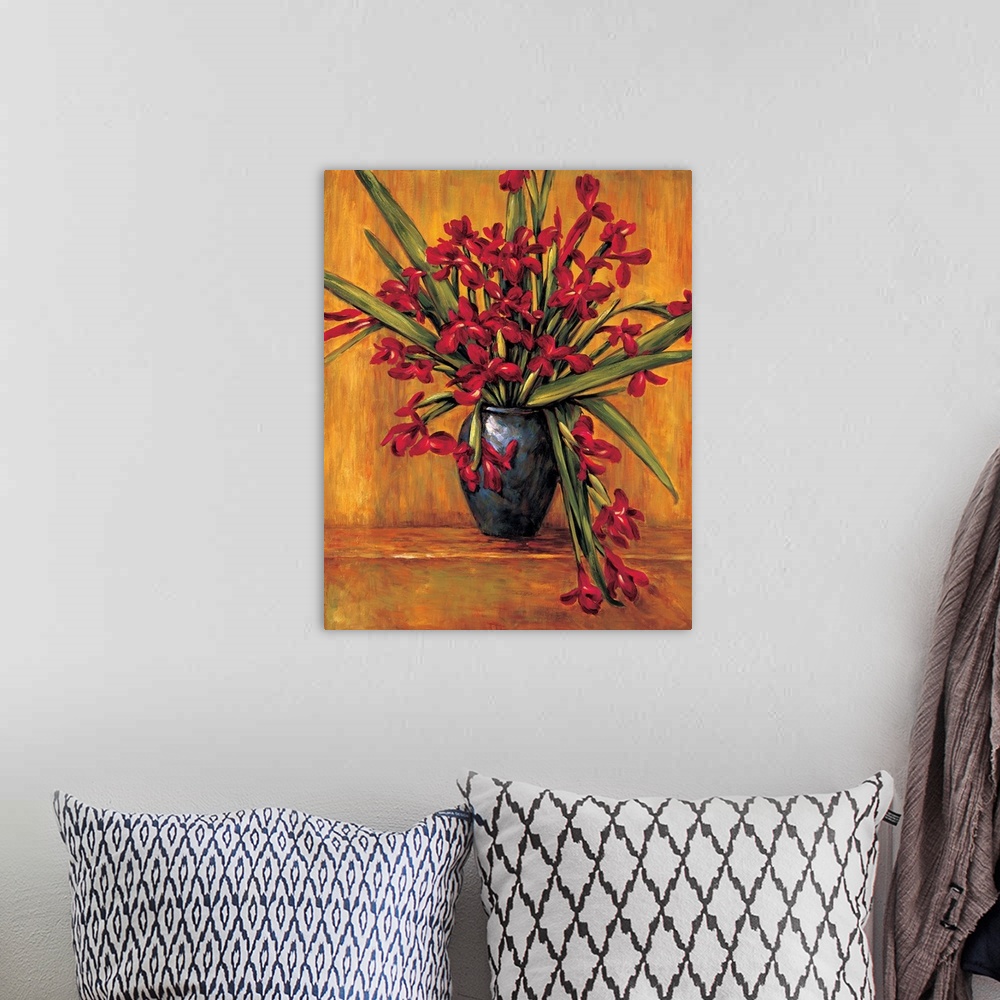 A bohemian room featuring Contemporary painting of red irises in a vase with an orange, red, and brown background.