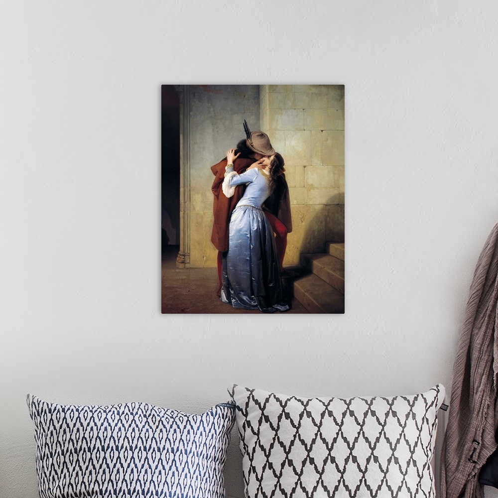 A bohemian room featuring 19th century classic painting of a man kissing a woman in a stone hallway.