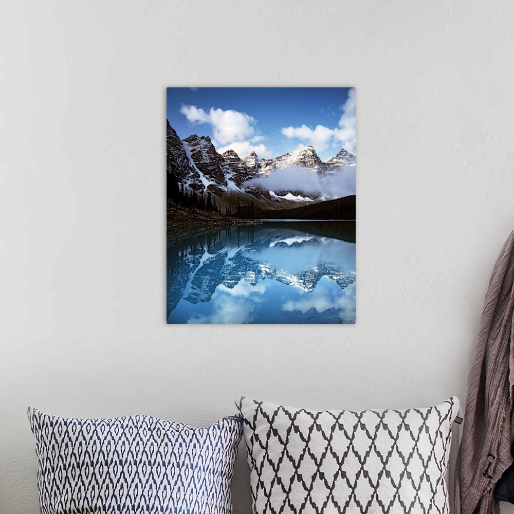 A bohemian room featuring Moraine Lake surrounded by snow-capped mountains in Banff National Park, Alberta, Canada.