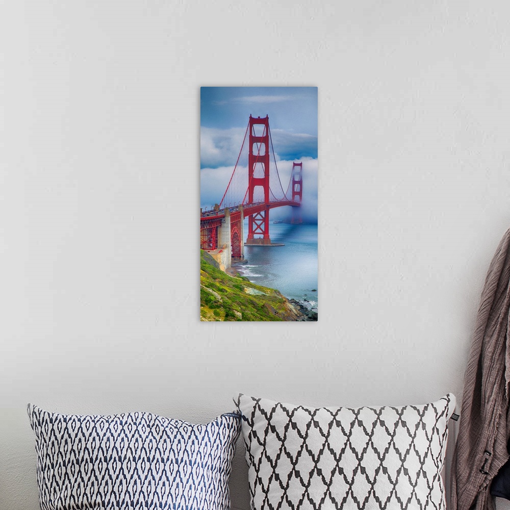 A bohemian room featuring Tall photograph of a green coast and the Golden Gate bridge with thick fog.