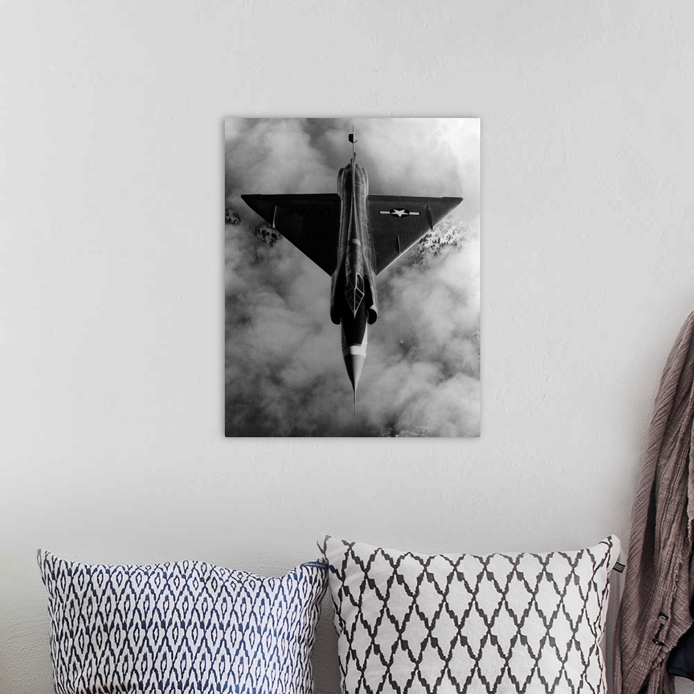A bohemian room featuring A United States Air Force, delta-wing F-102A, interceptor aircraft in flight above cloud cover.