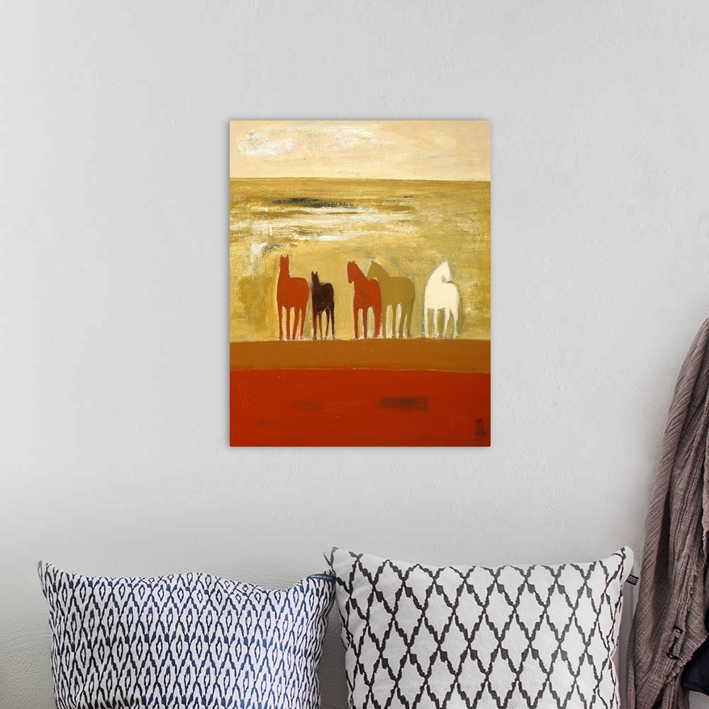A bohemian room featuring Portrait painting on a large wall hanging of five silhouetted horses in various colors, standing ...