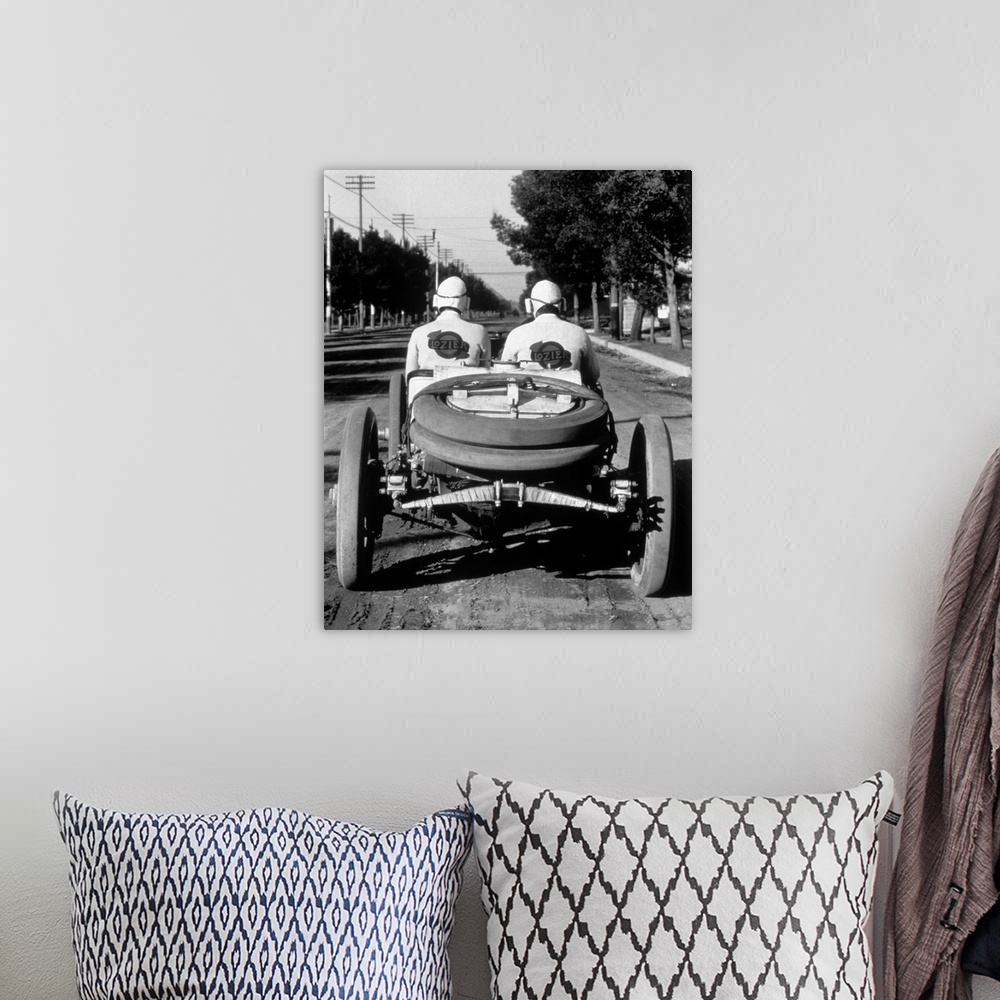 A bohemian room featuring 1900's 1910's Rear View Of Two Men Sitting In Antique Lozier Racing Road Rally Car.