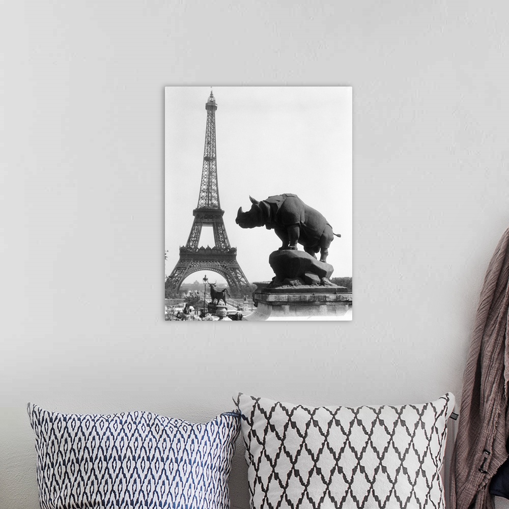 A bohemian room featuring 1920's Rhinoceros Statue In Foreground Eiffel Tower In Background Paris France.
