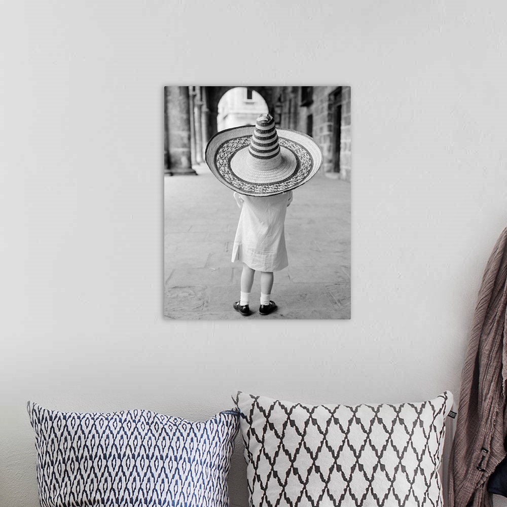 A bohemian room featuring 1950's 1960's Small Girl Tourist Seen From Behind Wearing Oversized Too Big Straw Hat.