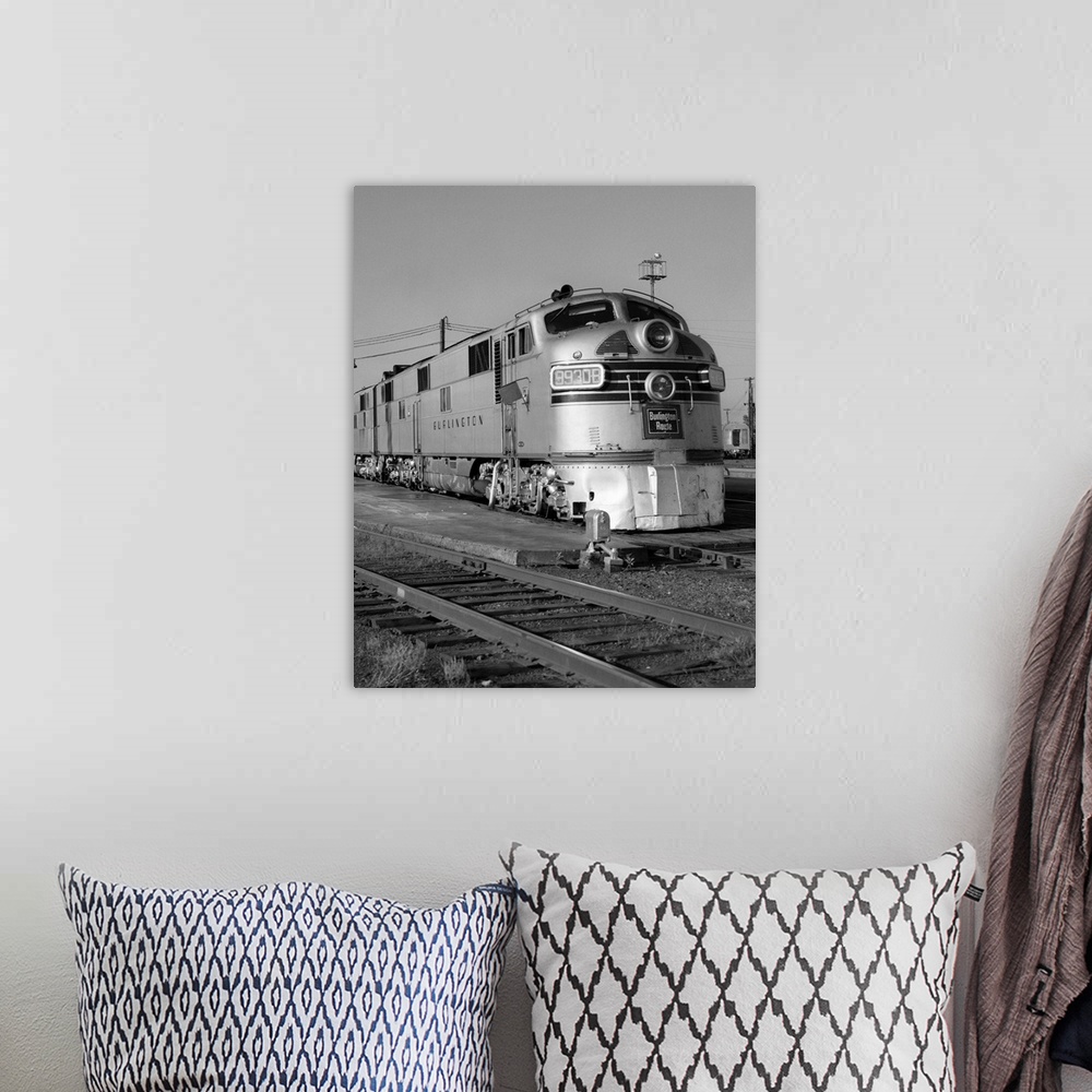 A bohemian room featuring 1950's 1960's Streamlined Burlington Route Railroad Train Diesel Locomotive Engine At Station.