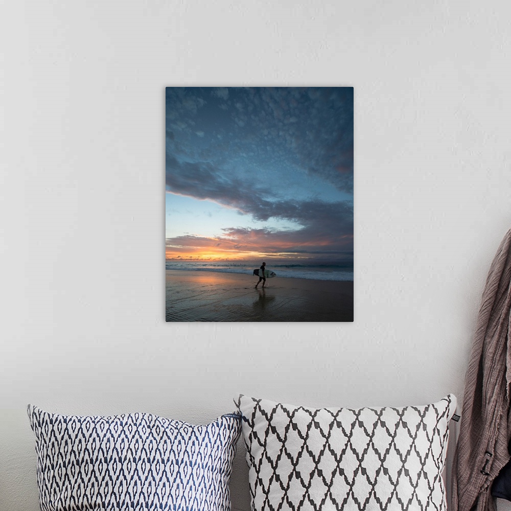A bohemian room featuring Surfer walking on the beach at sunset, Hawaii, USA