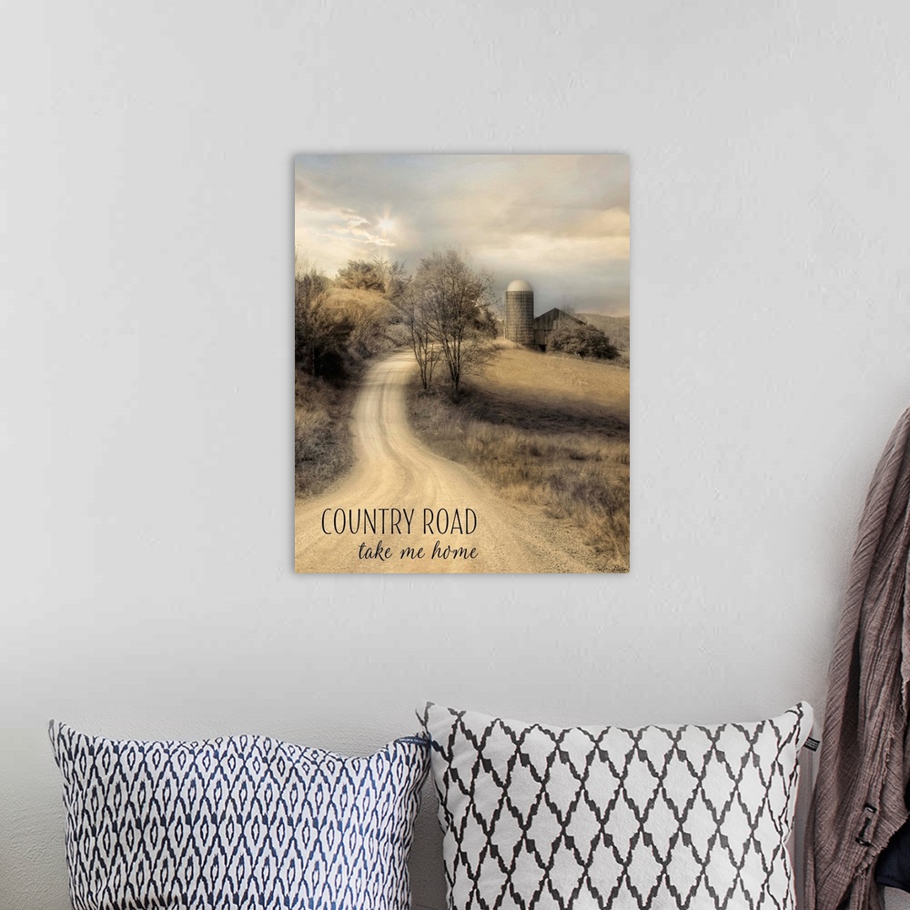 A bohemian room featuring Text over an image of a dirt road leading to a farm and silo in the countryside.