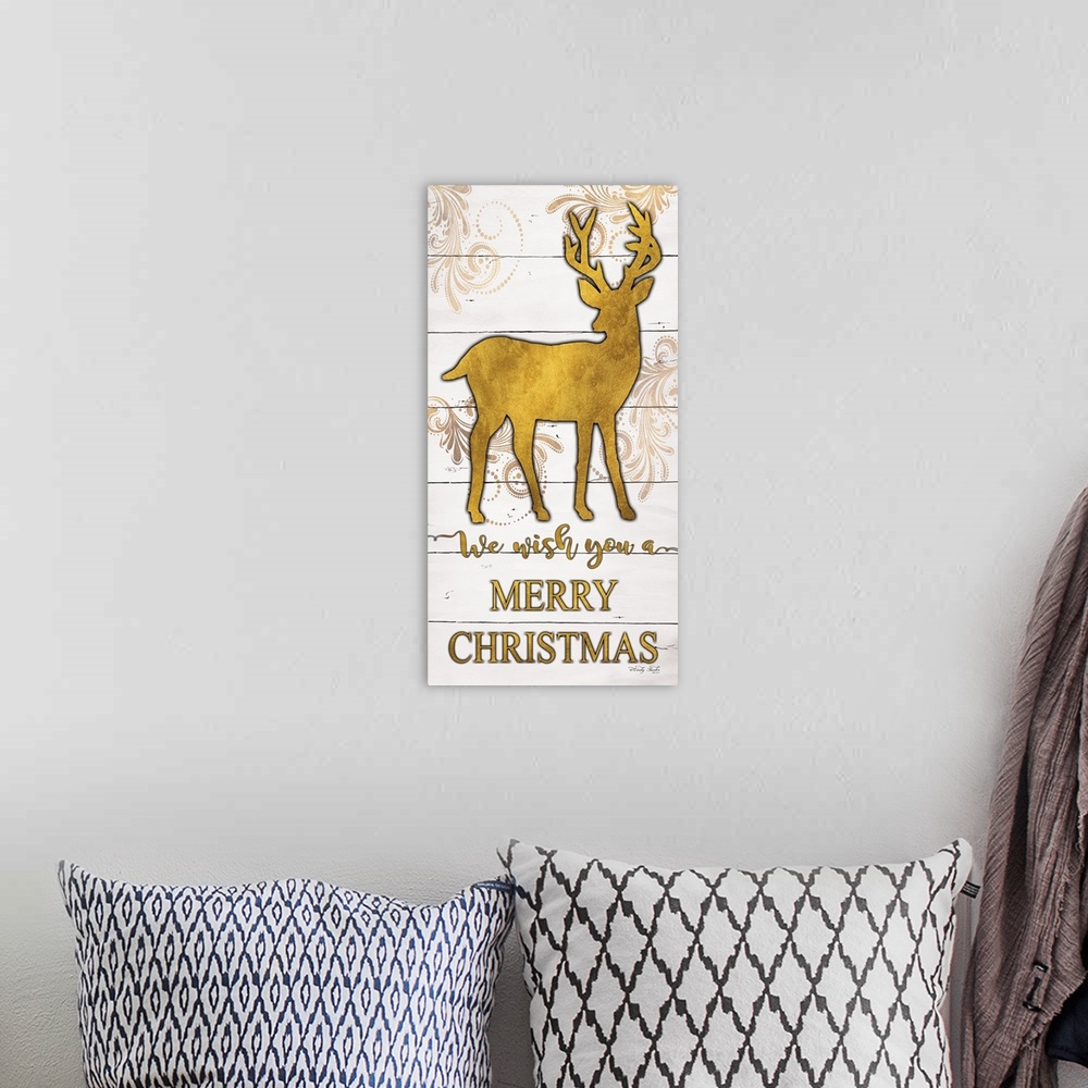 A bohemian room featuring The holiday sentiment, we wish you a merry Christmas, is in gold color letters underneath deer si...