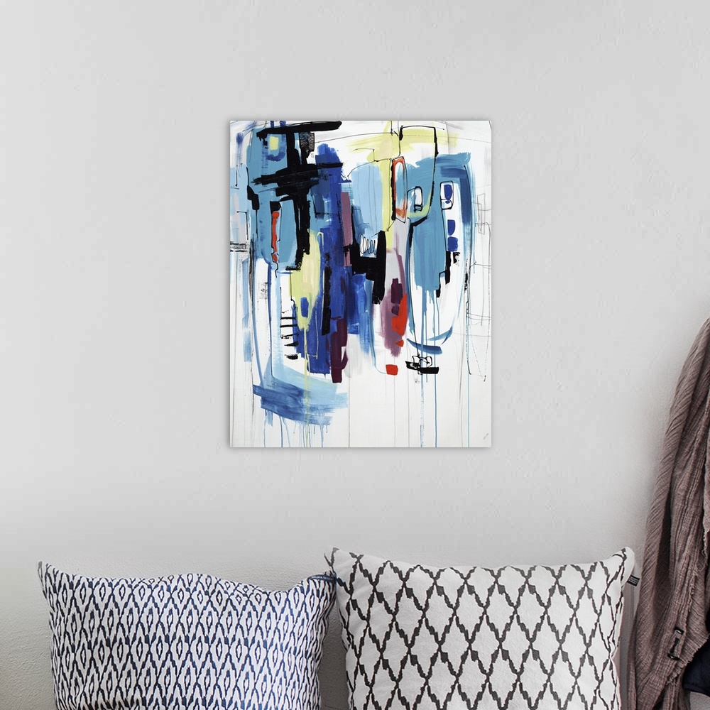 A bohemian room featuring Abstract painting of lines and blotches of various colors on a white canvas.