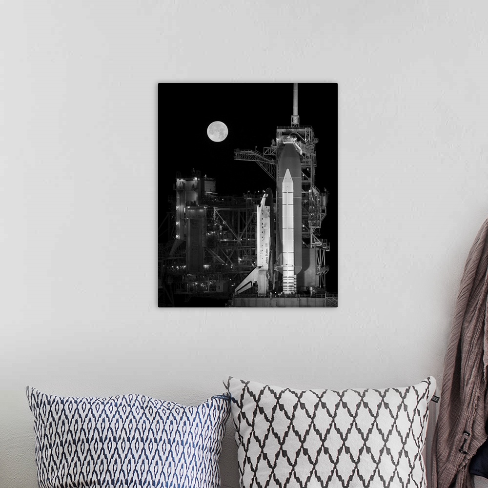 A bohemian room featuring Space Shuttle Discovery sits atop the launch pad with a full moon in background.