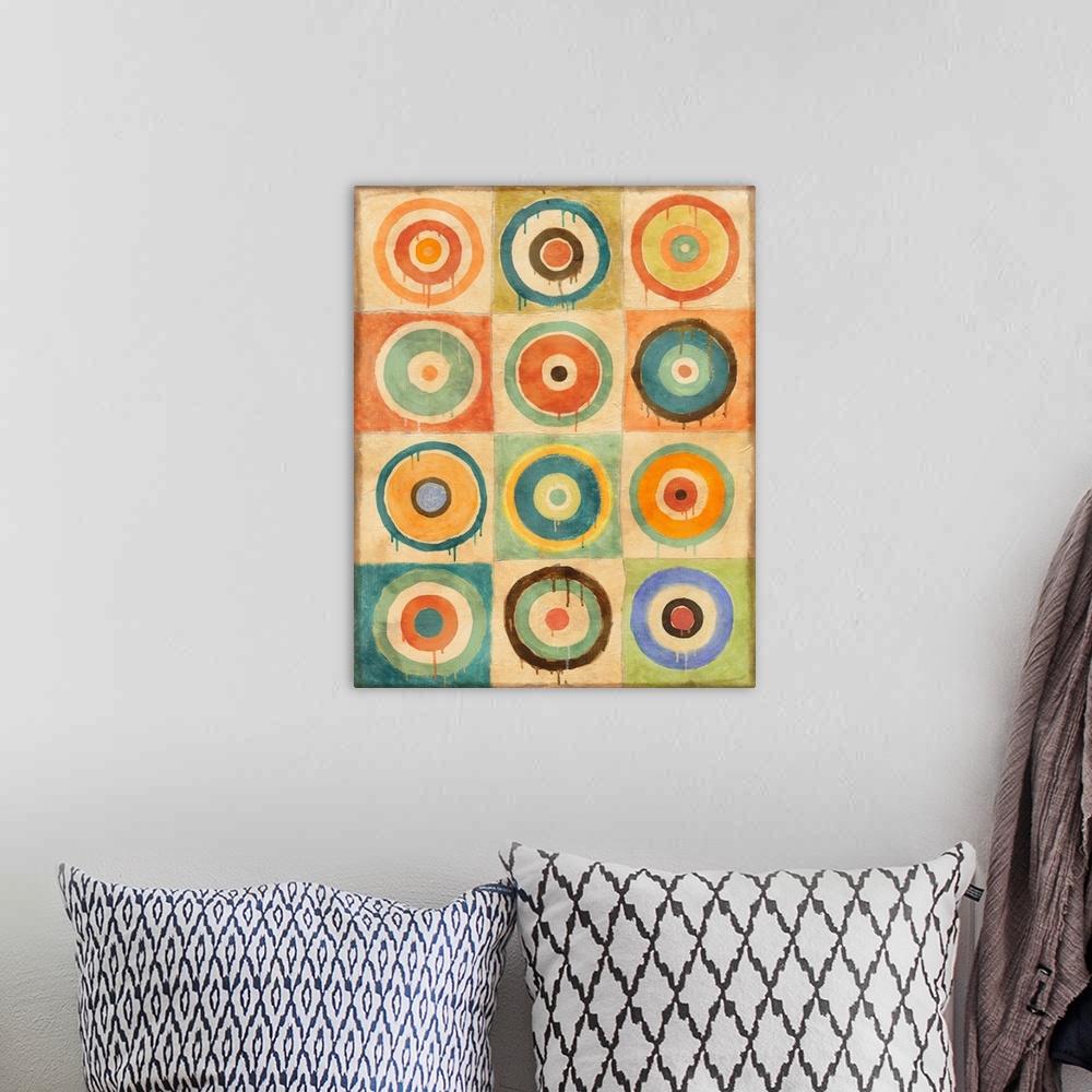 A bohemian room featuring Abstract geometric artwork of multicolored concentric circles.