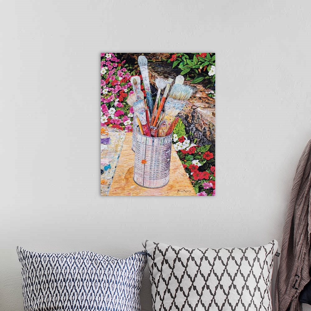 A bohemian room featuring A painting of a can full of used paint brushes set in an outdoor scene surrounded by flowers.