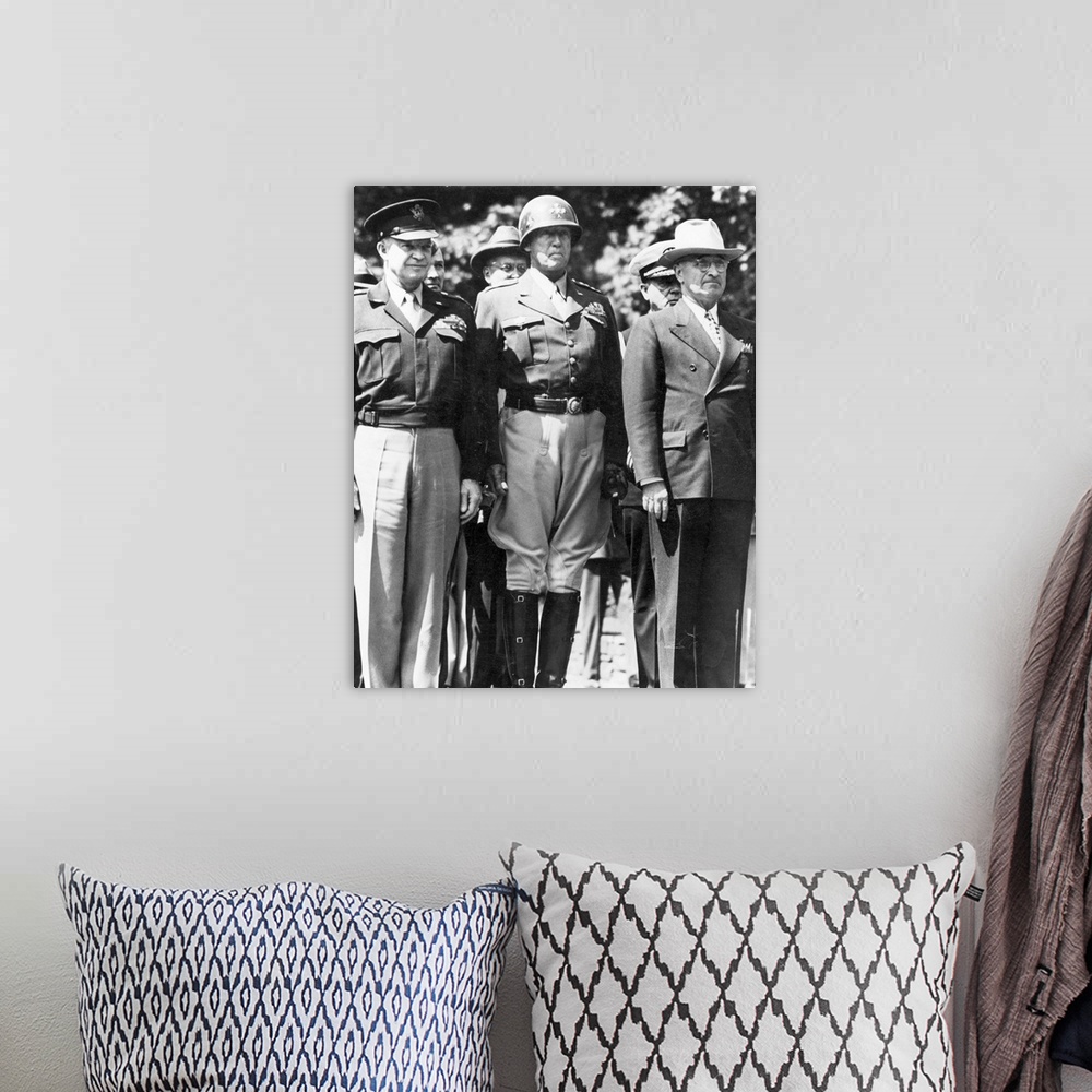 A bohemian room featuring General Dwight D. Eisenhower, General George S. Patton, and President Harry S. Truman watching as...