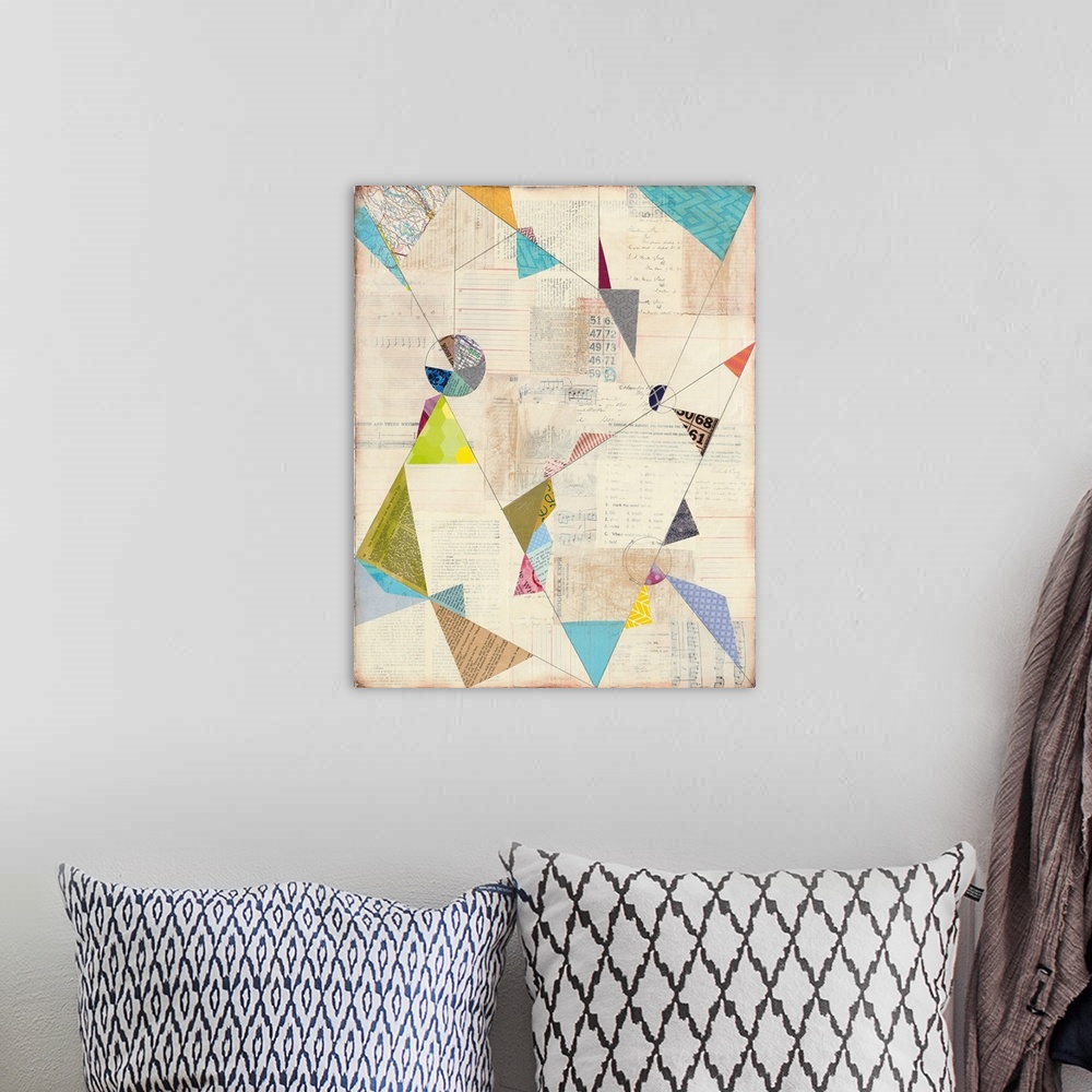 A bohemian room featuring Geometric abstract artwork with colorful triangle shapes.