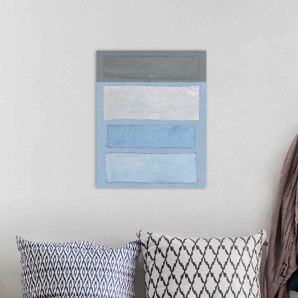 A bohemian room featuring Mixed media art with blue and gray linen rectangles placed horizontally on a vertical canvas with...