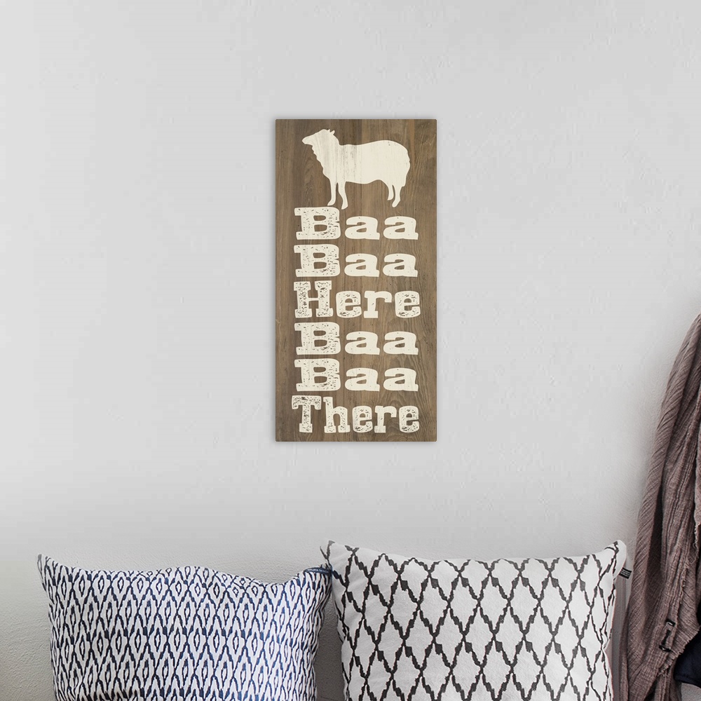 A bohemian room featuring "Baa Baa Here Baa Baa There" written on a wooden background with a sheep silhouette at the top.