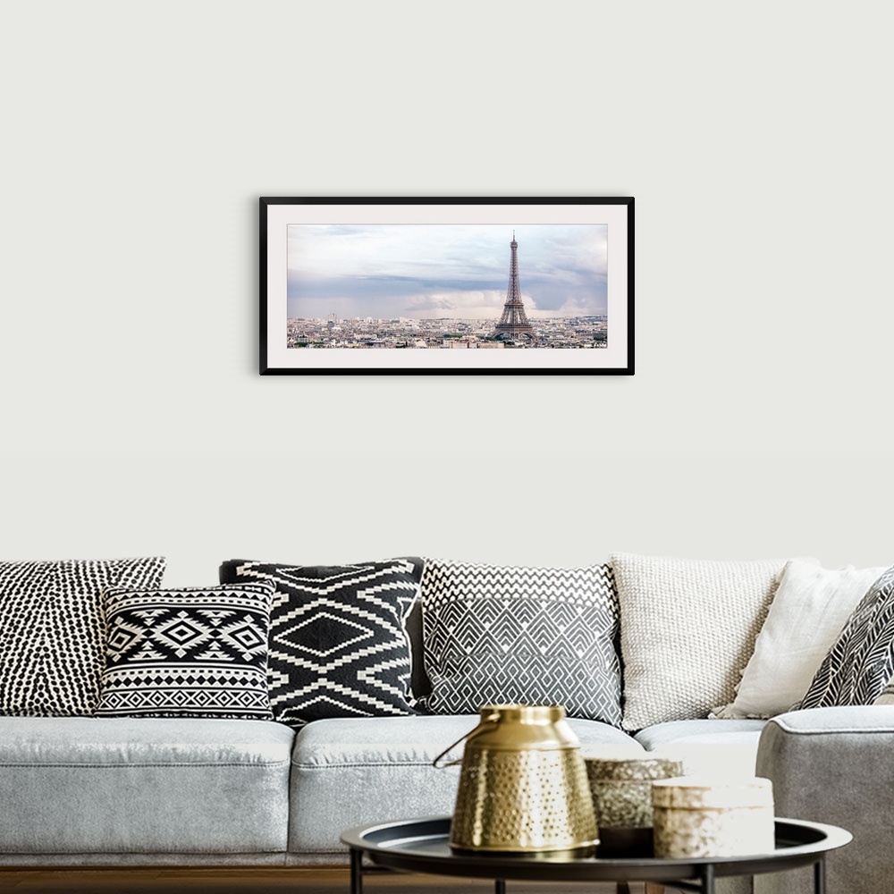 A bohemian room featuring Panoramic photograph of the city of Paris highlighting the Eiffel Tower.
