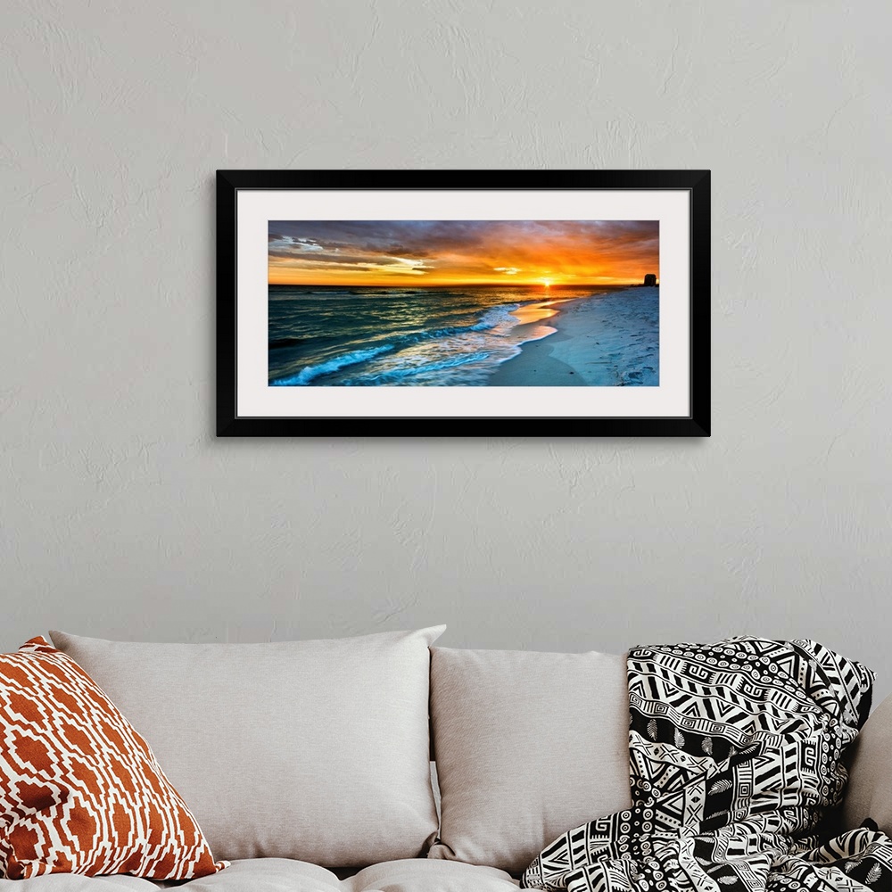 A bohemian room featuring A dark beach before a panoramic orange sunset with a burning red sky. Landscape taken on Navarre ...