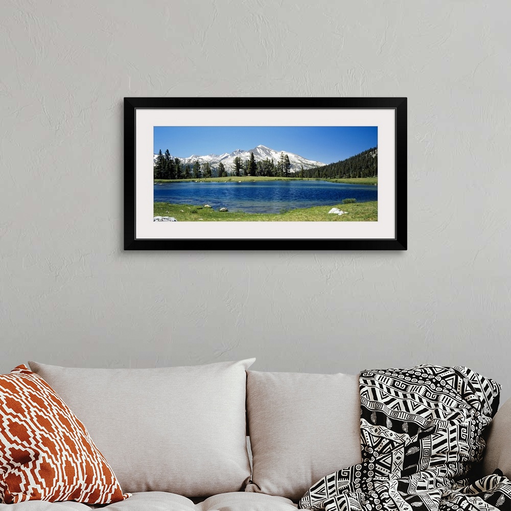 A bohemian room featuring Big canvas photo of a lake with snow covered mountains in the distance.