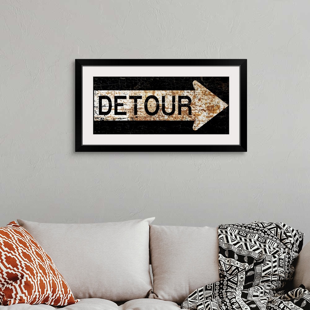A bohemian room featuring A worn, distressed, cracked and rusty Detour street sign.