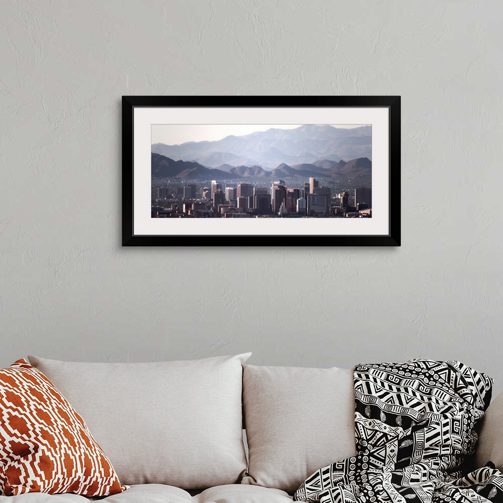 A bohemian room featuring Panoramic photograph of the Phoenix, Arizona skyline with hazy desert mountains in the background.