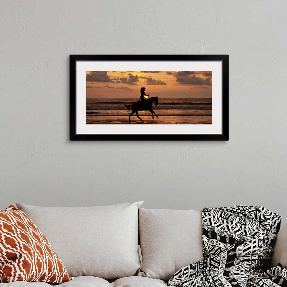 A bohemian room featuring Woman riding a horse on the beach at sunset in Costa Rica