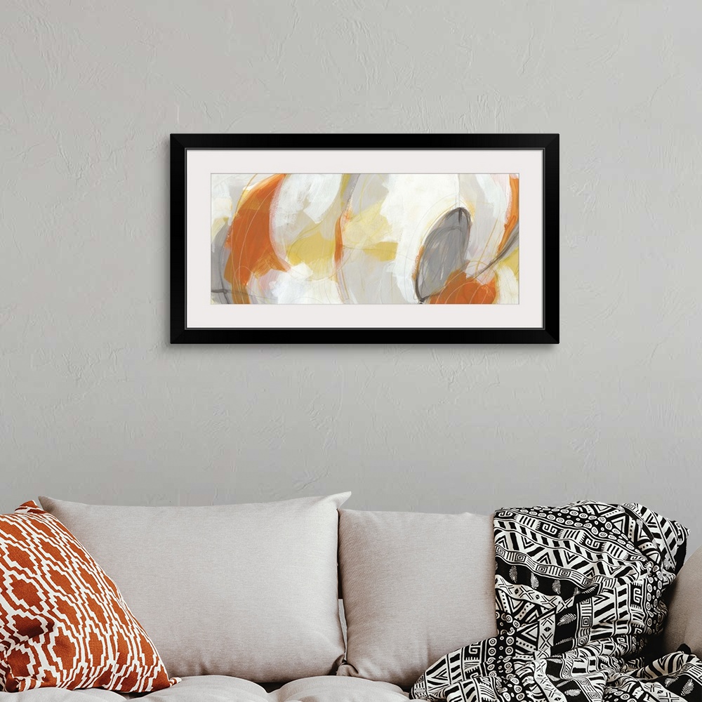 A bohemian room featuring Abstract artwork in large oval shapes in orange, yellow and white.
