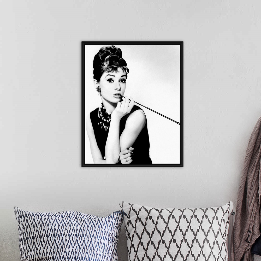A bohemian room featuring This wall art is a portrait photograph of the Hollywood Icon character Holly Golightly in her sig...