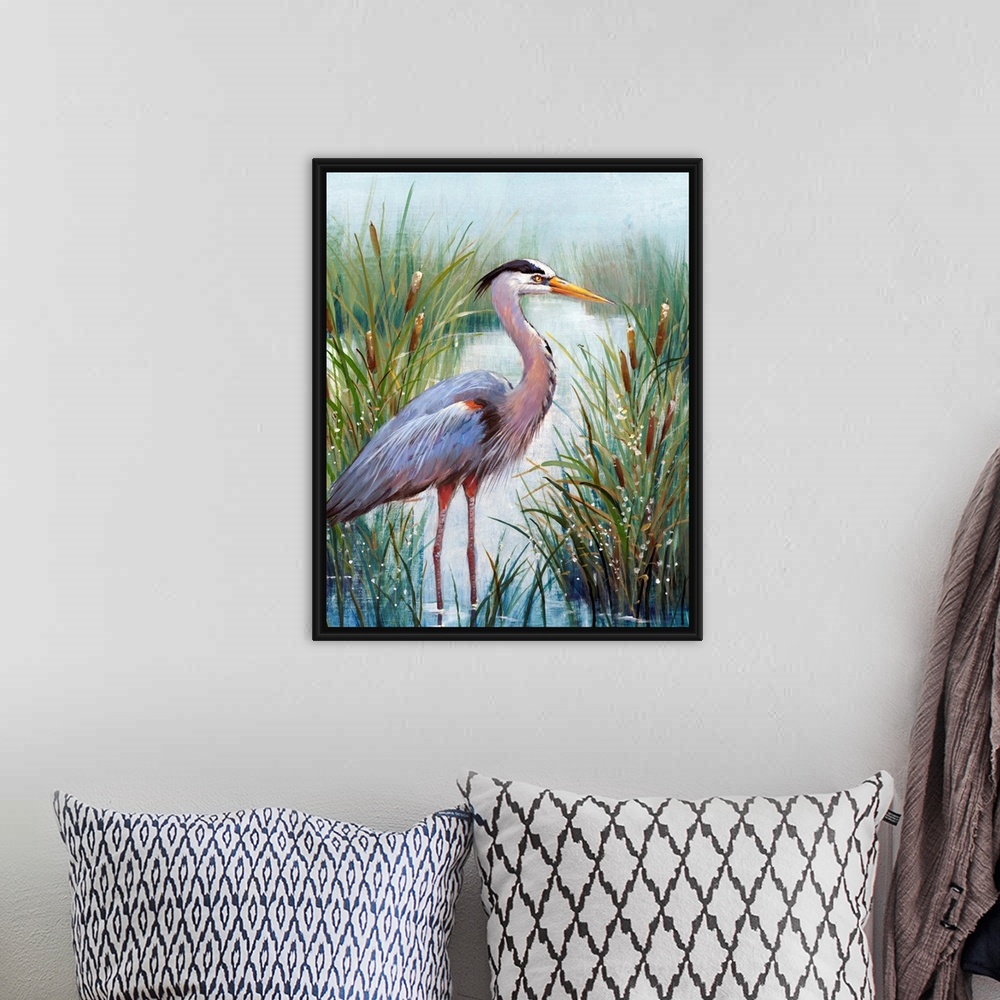A bohemian room featuring In this contemporary artwork, a stoic heron wades in the water with tall grasses and cattails wor...