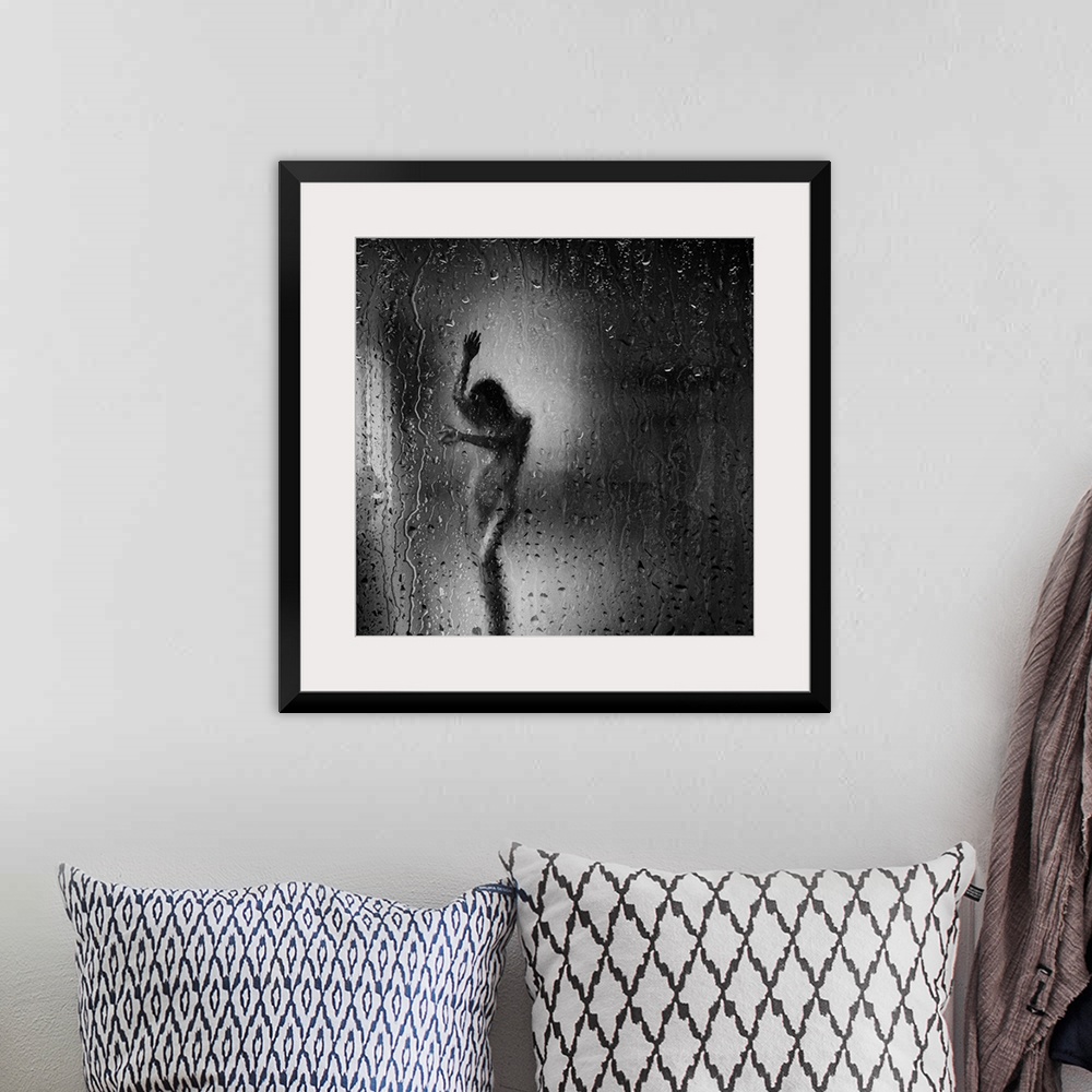 A bohemian room featuring Square black and white fine art photograph of a nude woman through a rainy window glass.