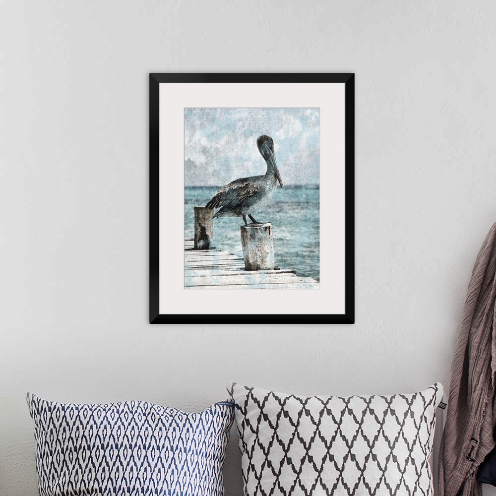 A bohemian room featuring Black and white photograph of a pelican standing on a dock with light blue tones painted on top.