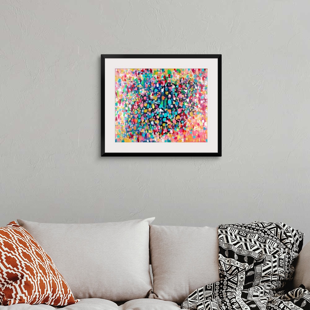 A bohemian room featuring Contemporary abstract painting of vivid multicolored spots, resembling confetti.