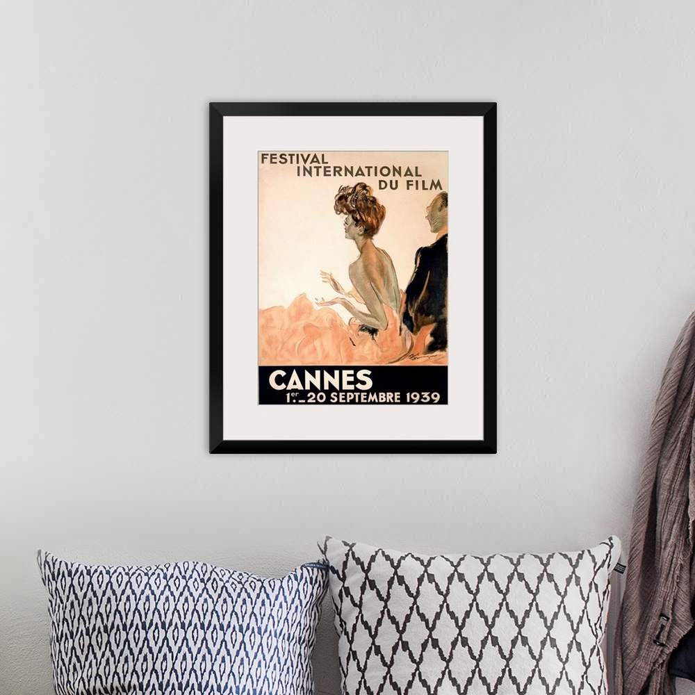 A bohemian room featuring Vintage advertising poster from 1939 showing a woman in a gown and a man in a tuxedo watching a f...