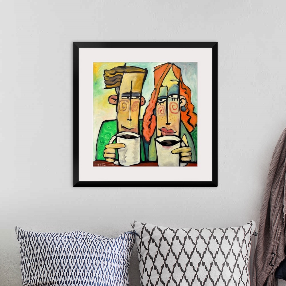 A bohemian room featuring Square painting of two cartoon like figures enjoying mugs of coffee.
