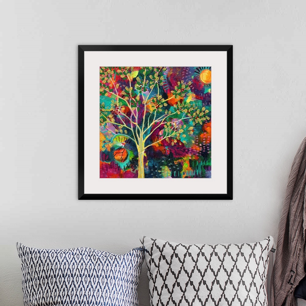A bohemian room featuring Abstract painting of a golden tree on a busy, colorful, square background with a sun on each side.