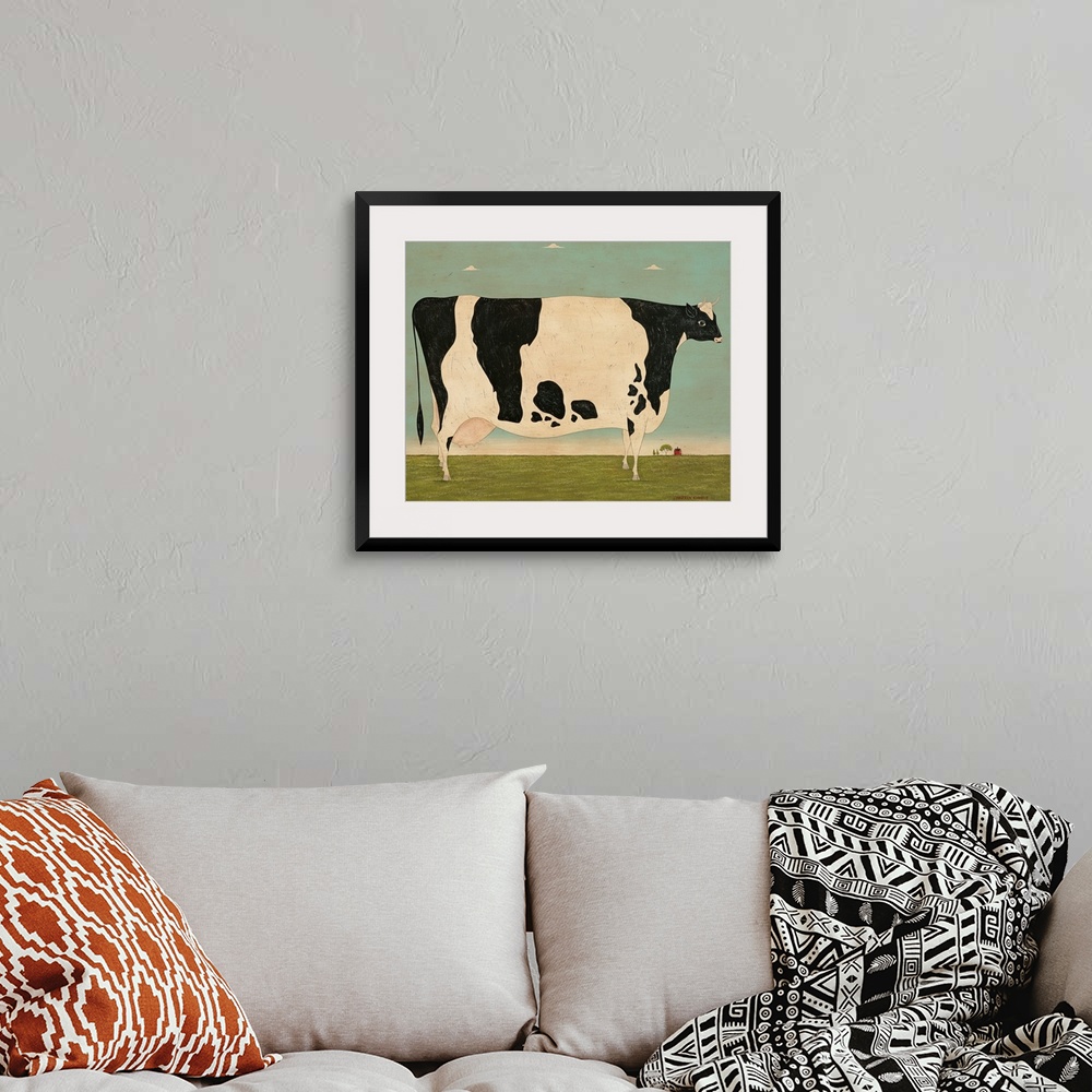 A bohemian room featuring Painting of a very large spotted cow in a green pasture on a Vermont farm.