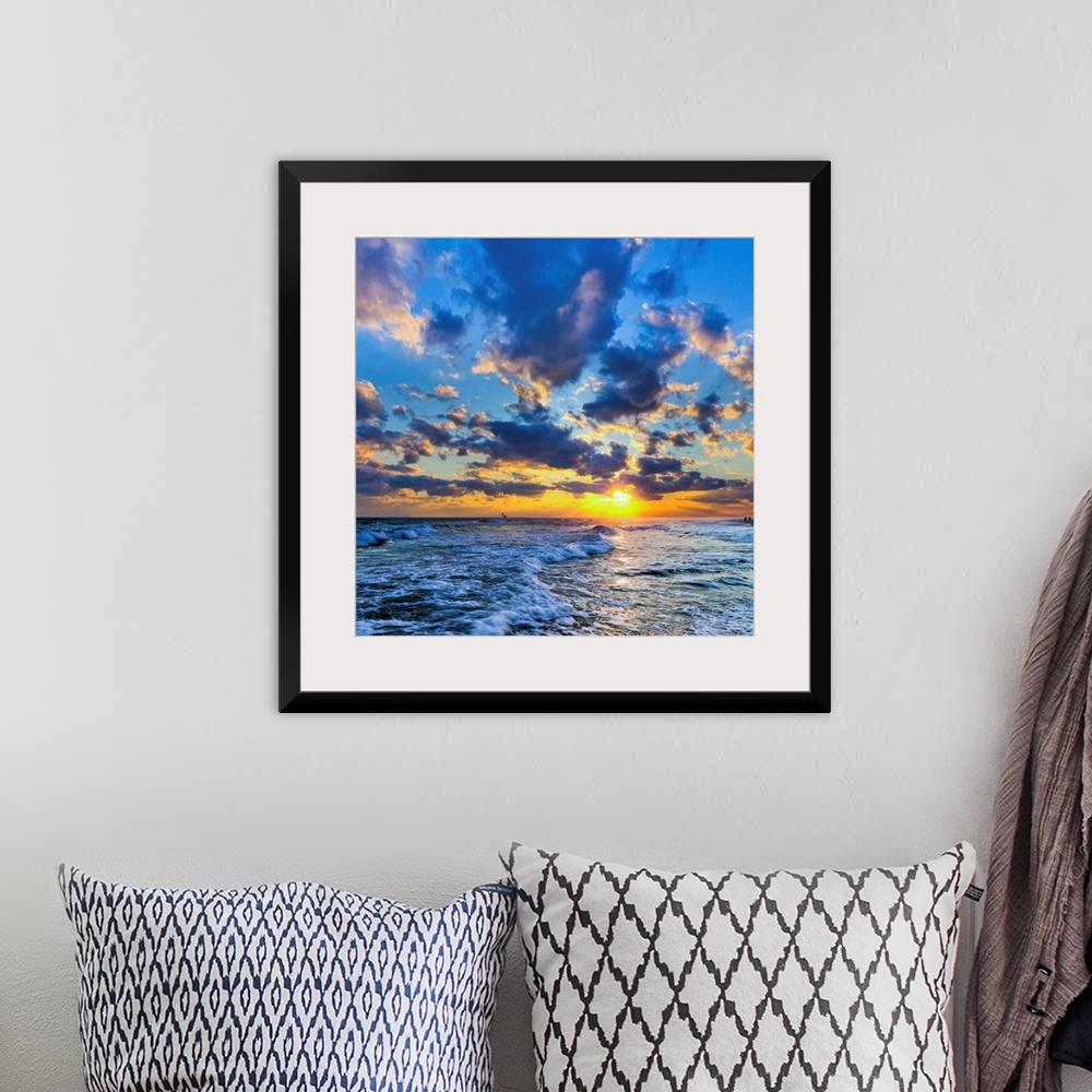A bohemian room featuring A Florida sunset with expanding puffy blue clouds during winter.