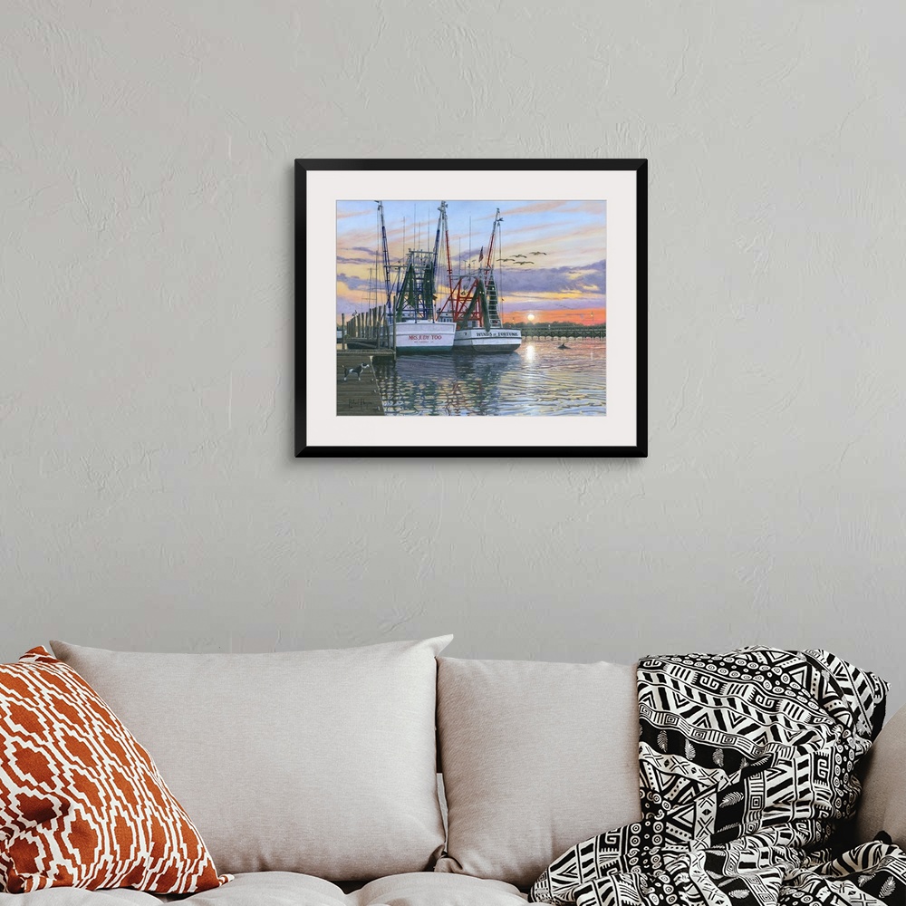 A bohemian room featuring Contemporary artwork of two fishing oats sitting in a harbor at sunset.