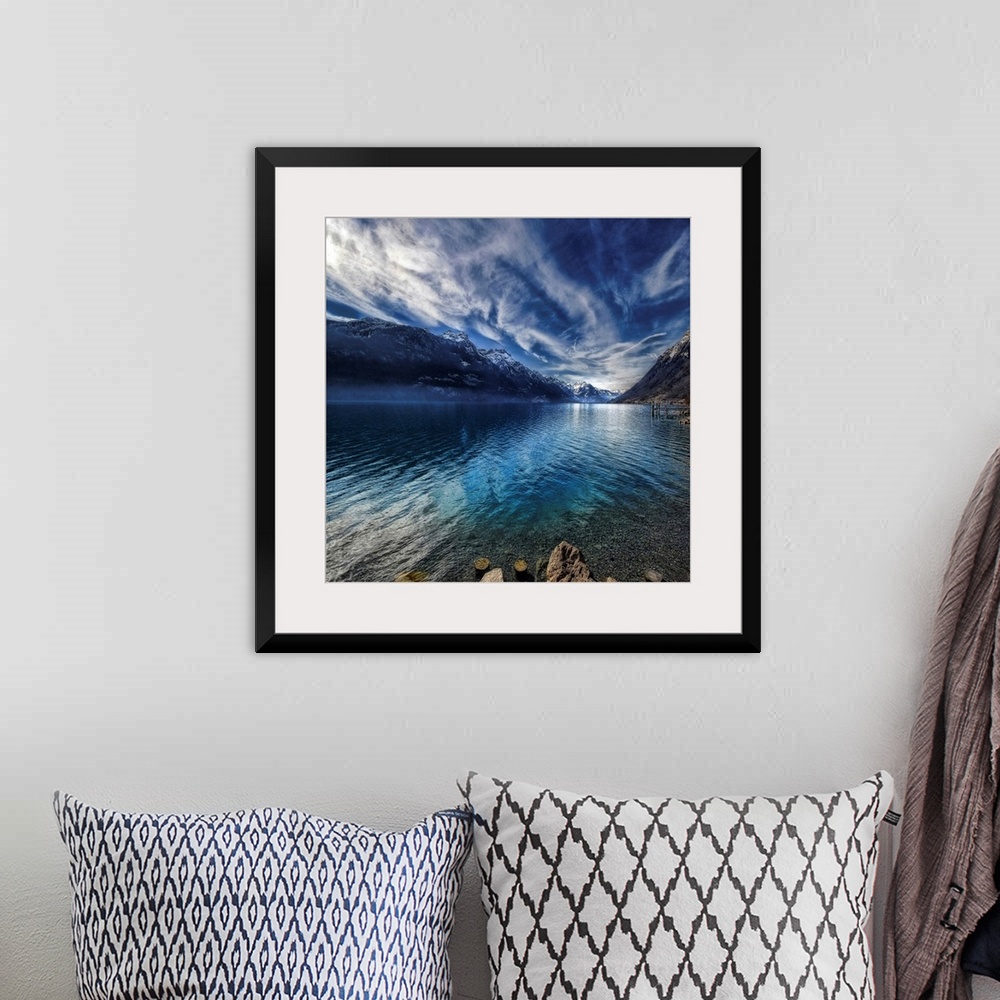 A bohemian room featuring This square shaped decorative wall art is a landscape photograph of a lake surrounded by snow cov...