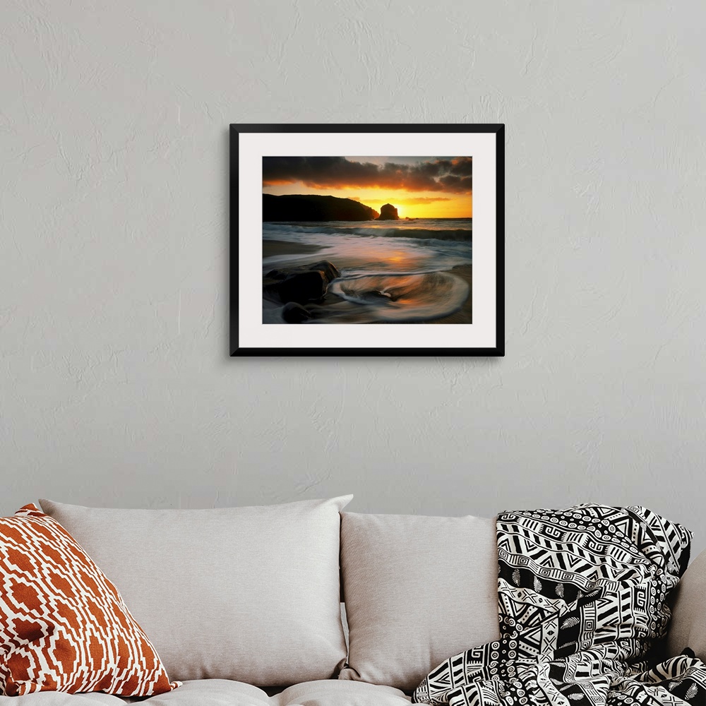 A bohemian room featuring Beautiful time lapsed photography wall art of waves on the beach at sunset.